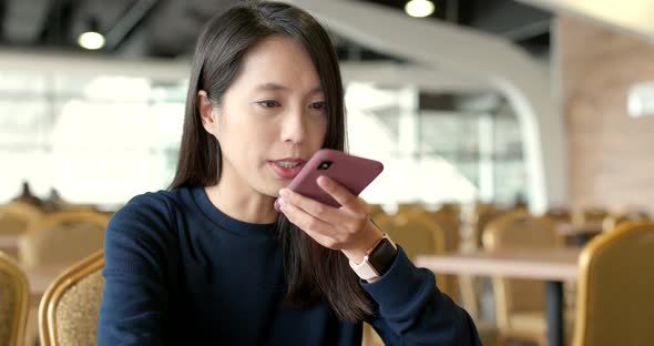 Woman use of mobile phone in restaurant