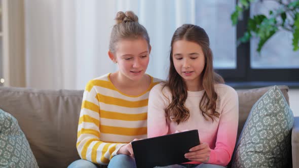 Happy Teenage Girls with Tablet Computer at Home