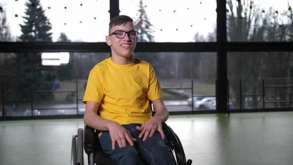 Portrait of Disabled Teen Boy in Wheelchair Indoor