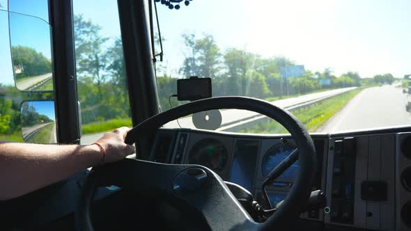 Unrecognizable Lorry Driver Driving on Country Road at Sunny Day