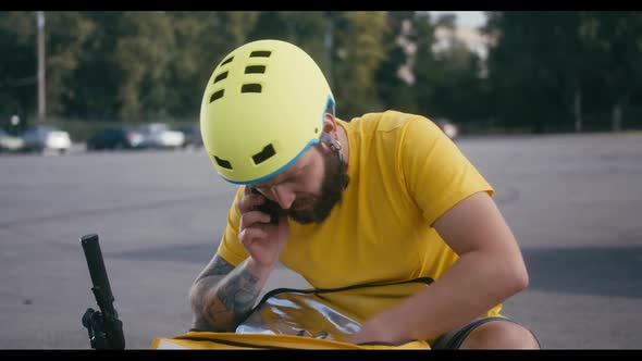 Delivery Man Searching in His Backpack