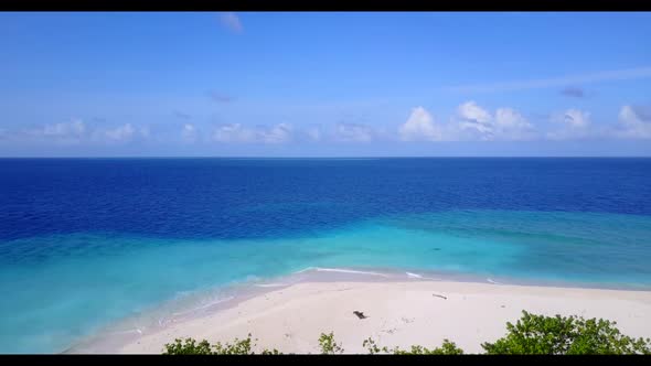 Aerial flying over scenery of paradise bay beach wildlife by clear water with white sandy background