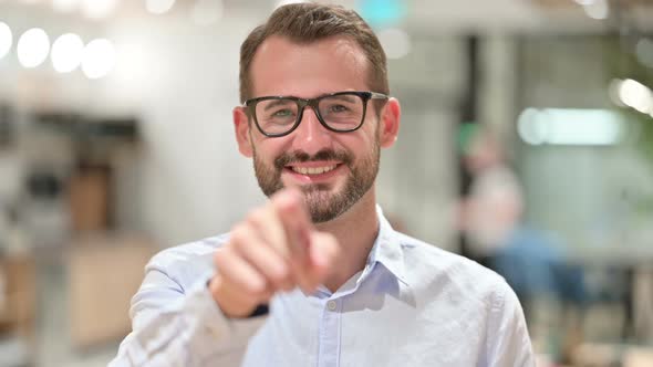 Portrait of Assertive Businessman with Pointing at the Camera