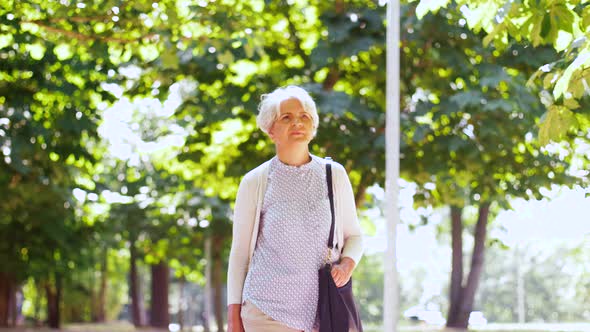 Senior Woman Walking Along Summer Park 13