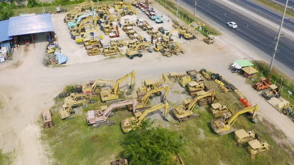 Aerial top view of new truck tractor cars parking for sale stock lot row, dealer inventory import