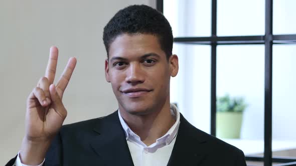 Victory Sign by Black Businessman