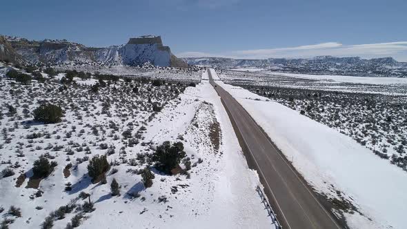 Flying along road through the vast snowy landscape in Utah