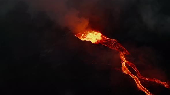 Night Footage of Flowing Molten Lava Stream Down on Slope