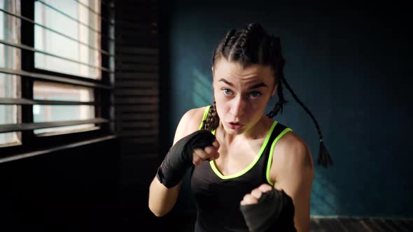 Young Boxing Woman Practicing her Punches