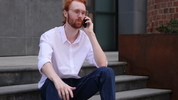 Young Designer Talking on Phone, Negotiating in Good Mood