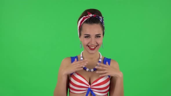 Portrait of Beautiful Girl in a Swimsuit Coquettishly Is Laughing. Green Screen