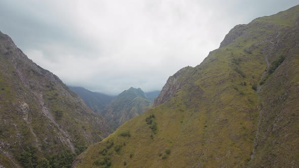 Picturesque gorge on heavy cloudy sky background