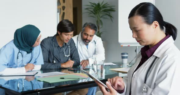 Female doctor using tablet in meeting 4k