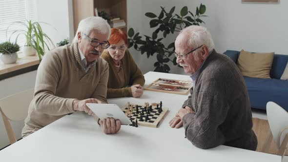 Modern Seniors Using Digital Tablet