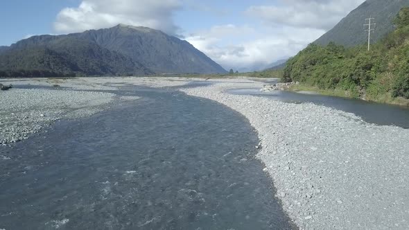 Shallow water of river in terrain with mountains