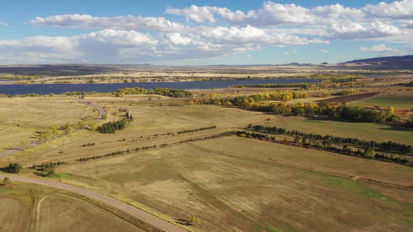 A pan along an open valley south of Denver.  Chatfield Reservoir is captured on the horizon