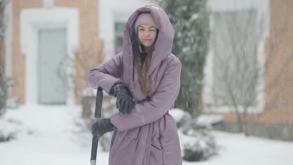 Middle Shot of Smiling Beautiful Caucasian Slim Young Woman Standing Outdoors on Snowy Winter Day