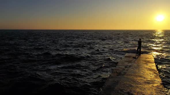 Slow Motion Female Walking by The Ocean with Waves on Sunset