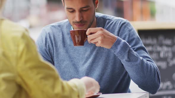 Front view of Caucasian man drinking coffee on a terrace