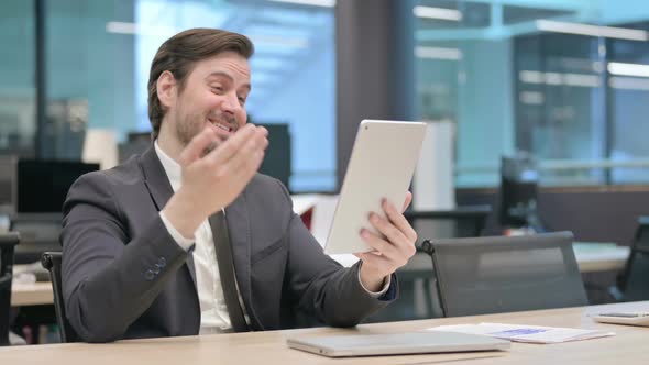 Businessman Making Video Call on Tablet in Office