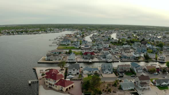Drone Wide Shot of Local Residential Suburb of River in View of Distant Toms River