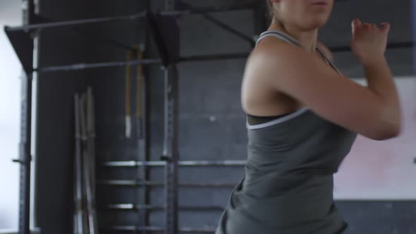 Professional Female Athlete Having Intensive Workout in Gym