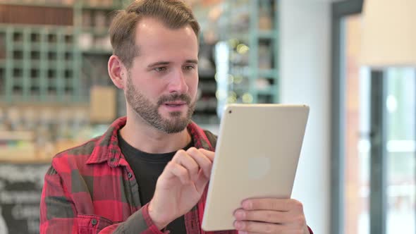 Portrait of Young Man Celebrating Success on Smartphone