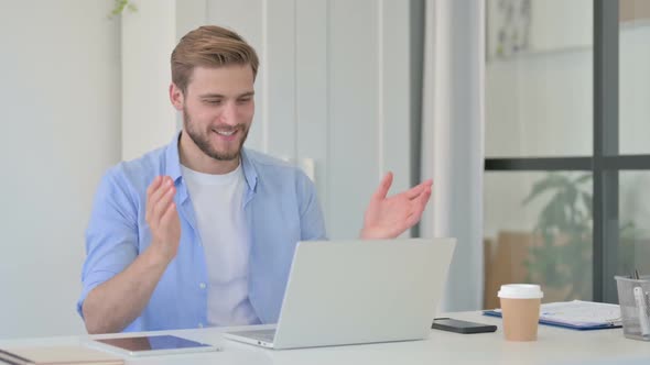 Young Creative Man Talking on Video Call on Laptop