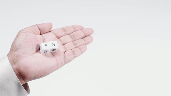 Hand Holds Numbered Dice   Five And Three Fifty Three 