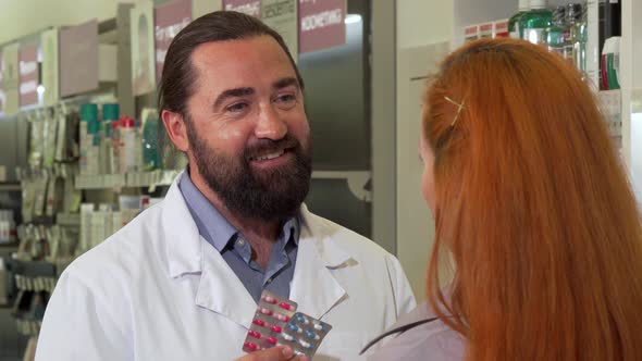 Friendly Male Pharmacist Selling Pills To Female Customer