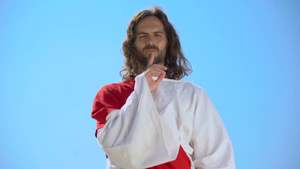 Jesus Showing Silence Gesture on Sky Background, Speechless Prayer, Deep Faith