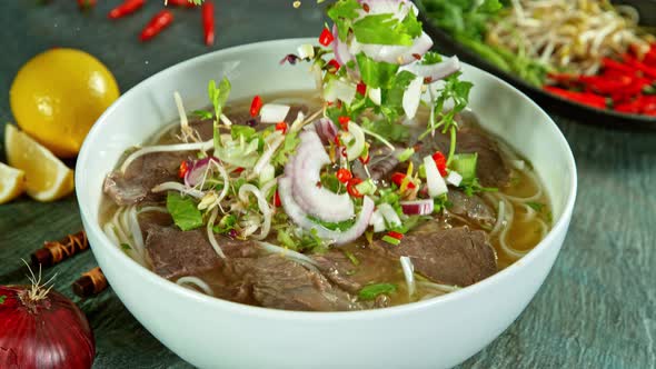 Super Slow Motion Shot of Ingredients Falling Into Beef Pho Soup at 1000 Fps