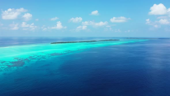 Tropical aerial clean view of a sandy white paradise beach and aqua blue ocean background in hi res 