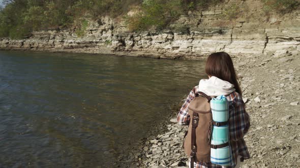 Woman with Backpack Walking on Riverside at Bakota Bay