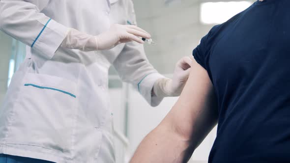 Doctor is Injecting Vaccine Into Patient's Arm