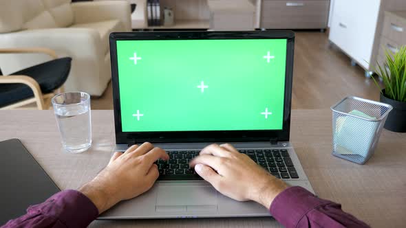 Male Hands Typing on the Laptop Keyboard with Chroma Green Screen Mock Up