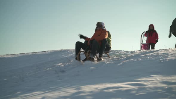 Laughing Best Ager Couple Tobogganing