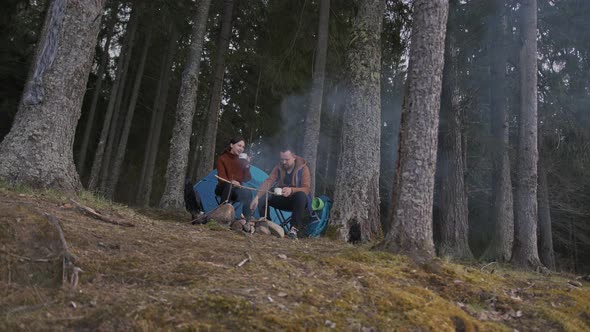 A Beautiful Cinematic Shot of Two Young Tourists a Man and a Woman in Wood