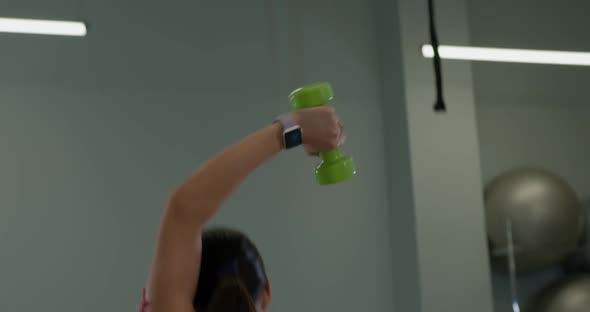 Athletic Brunette Girl Performs a French Press From Behind the Head