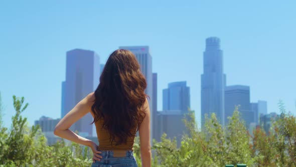 Woman Standing Back in Park Enjoy Skyscrapers View