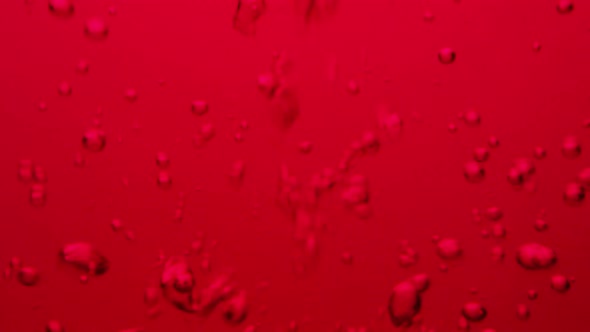 Bubbles in red water floating around alt
