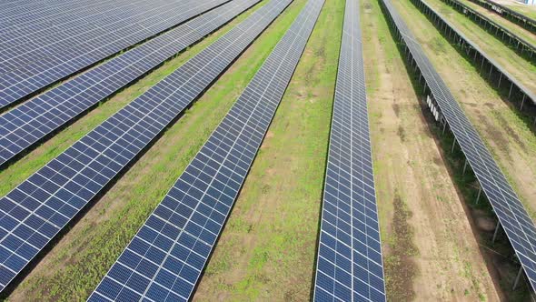 Aerial View of Solar Power Station. Solar Farm. Field of Solar Panels in a Row