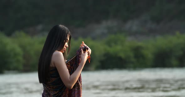 Asian Girl Wearing Sarong in a River