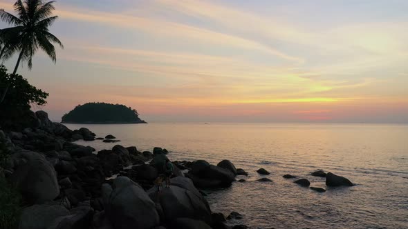 Tourists Watching Sunset On The Large Rock.