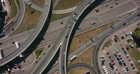 Aerial drone view of highway multi-level junction road with moving cars