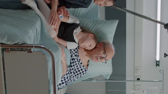 Vertical Video Little Girl and Mother Visiting Grandpa in Hospital Ward