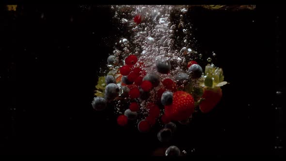 Falling Berries Into Water on a Black Background