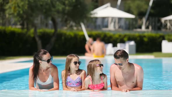 Happy Family in Swimming Pool