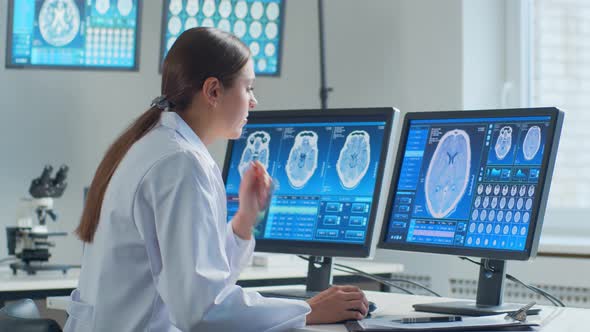 Professional medical doctor working in hospital office using computer technology.