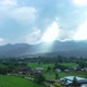 The Rays of the Sun Are Illuminate the Village on a Green Hill Near the Mountains - VideoHive Item for Sale